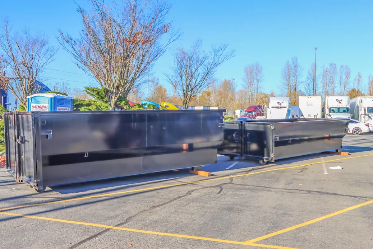 Professional dumpster rental service with roll-off container on residential driveway in North Hanover